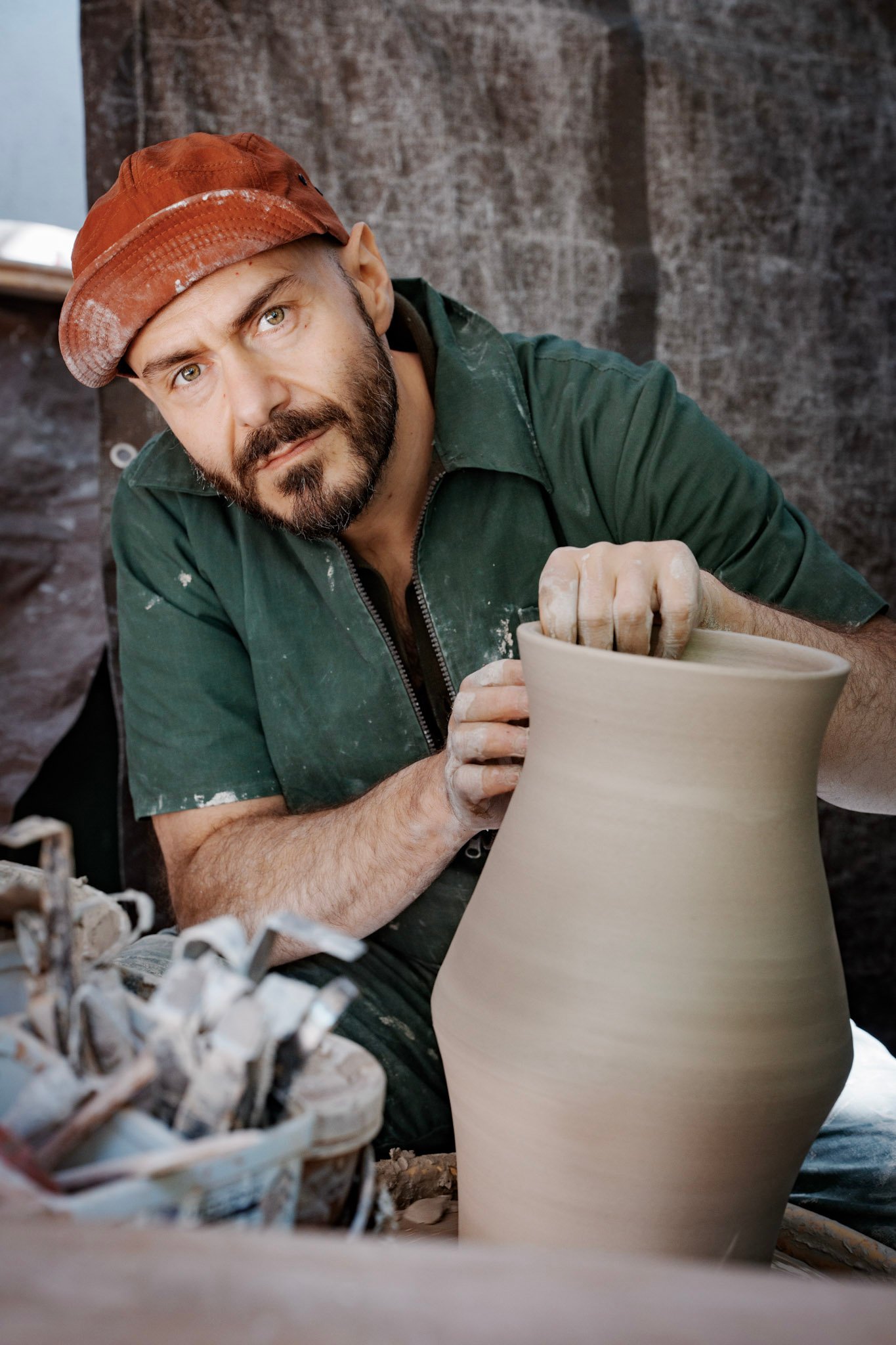 Alessio di Giambattista shaping a clay pot on an outdoor pottery wheel